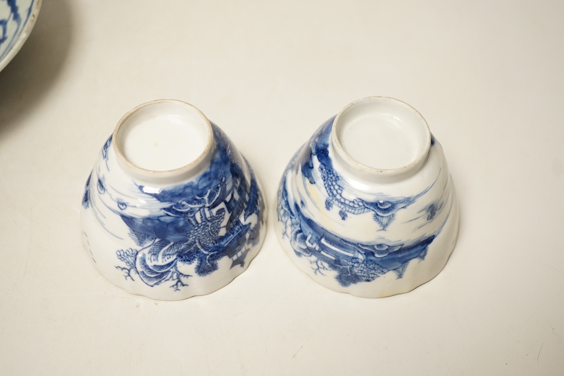 Two 19th century Chinese blue and white dishes and two 18th century tea bowls, largest 23cm diameter